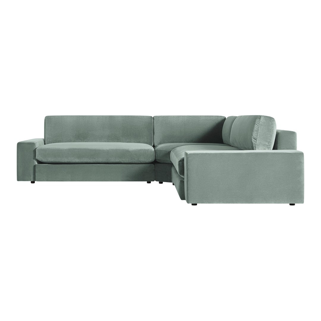 Soft, muted green velvet sectional sofa with sleek, modern design and smooth, solid upholstery. Ideal for contemporary decor.