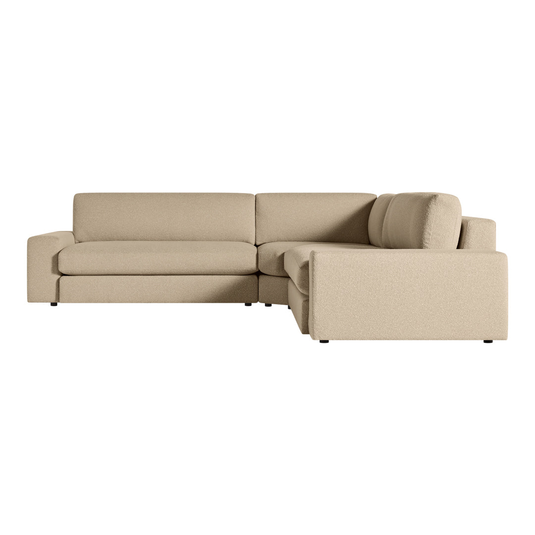 "Beige sectional sofa with a modern, minimalist design and soft, textured fabric."