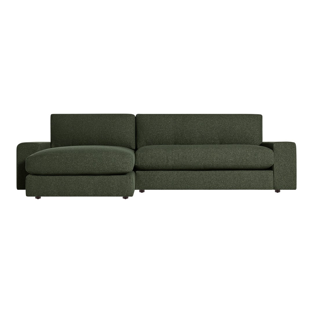 Modern green sofa in textured fabric with a minimalist design, featuring clean lines and plush cushions.