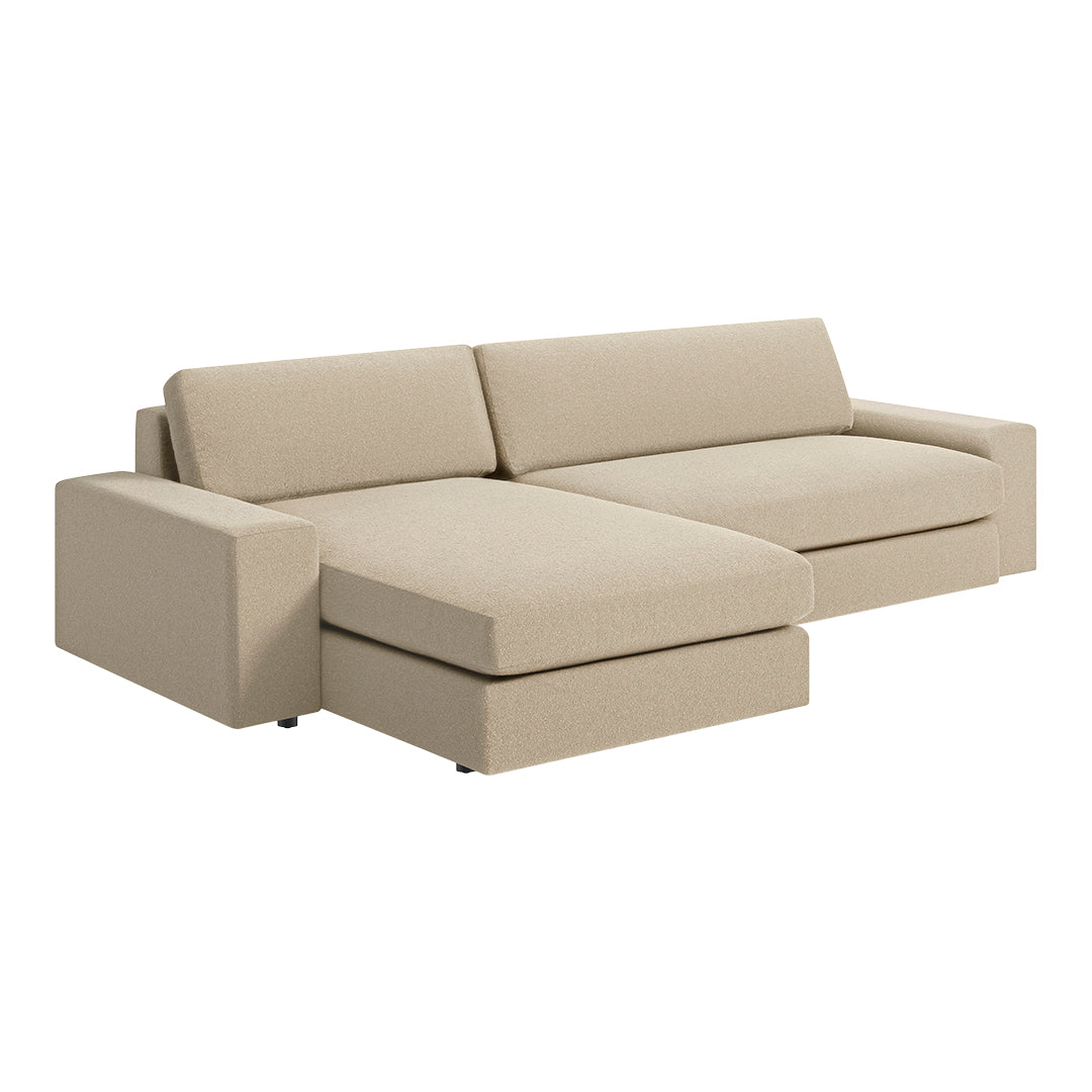 Beige sectional sofa with smooth, solid fabric and contemporary design featuring clean lines. Perfect for modern interiors.