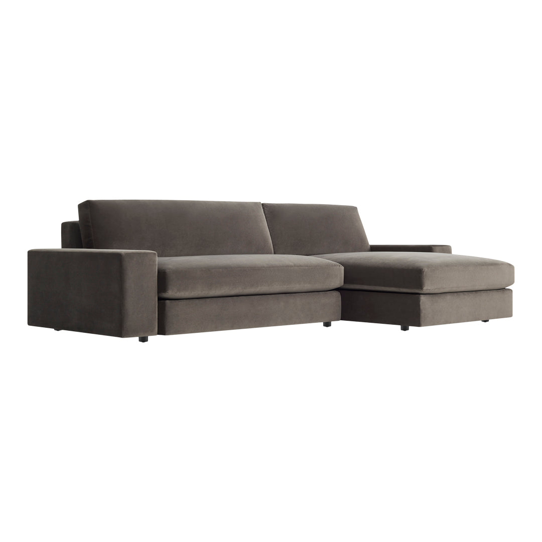 Gray velvet sectional sofa with clean lines and a modern design, perfect for contemporary living spaces.