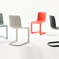 "Colorful modern chairs in gray, mint green, red, and black with sleek, minimalist designs on a white background."