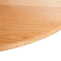 Light natural wood table surface with subtle grain patterns and a smooth circular edge finish.