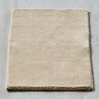 Beige square fabric with a subtle texture, perfect for adding warmth and elegance to any space.