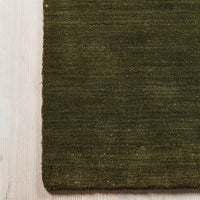 Olive green textured fabric with a subtle, natural pattern, perfect for adding warmth to any space.