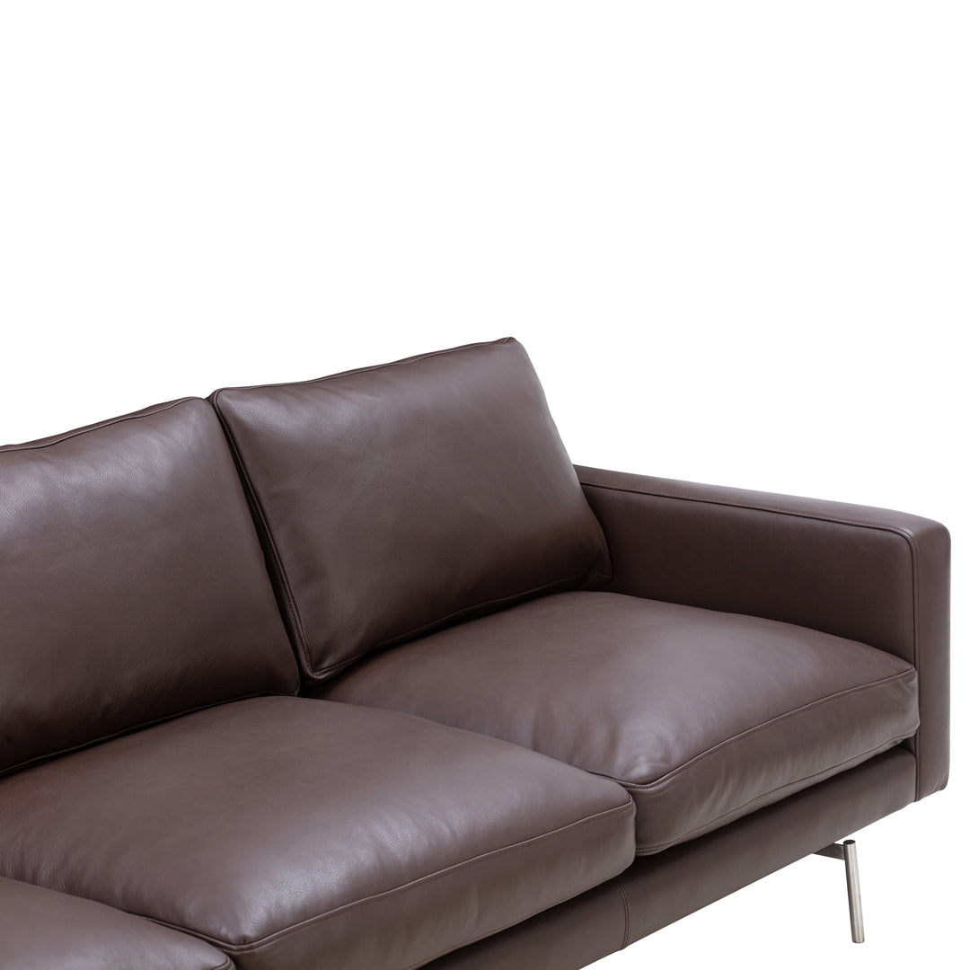 Brown leather sofa with sleek lines and plush cushions, perfect for modern living spaces.