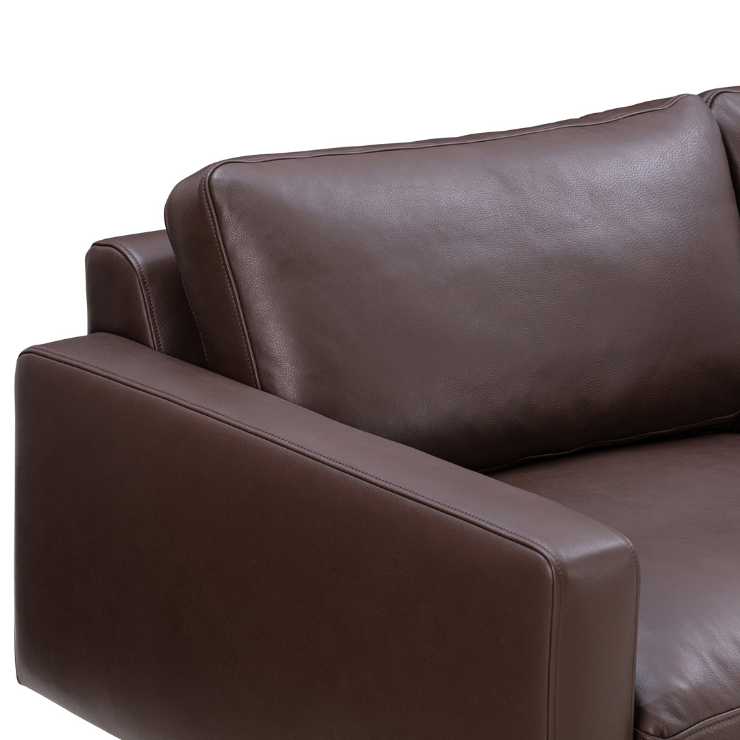 Brown leather couch with smooth texture and minimalist design showcasing deep, rich color.