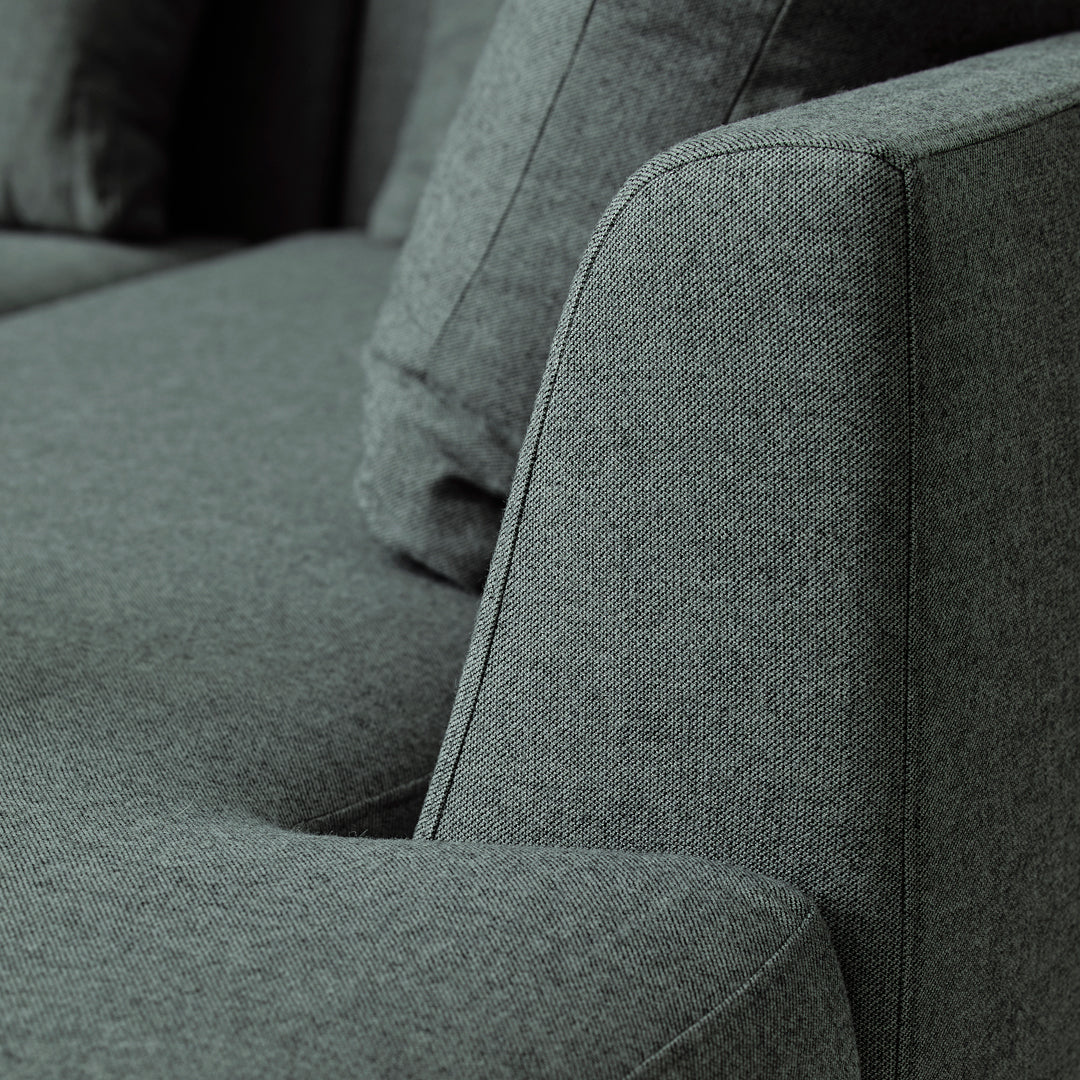 Gray textured fabric sofa with clean lines and subtle crosshatch pattern, showcasing a modern and stylish design.