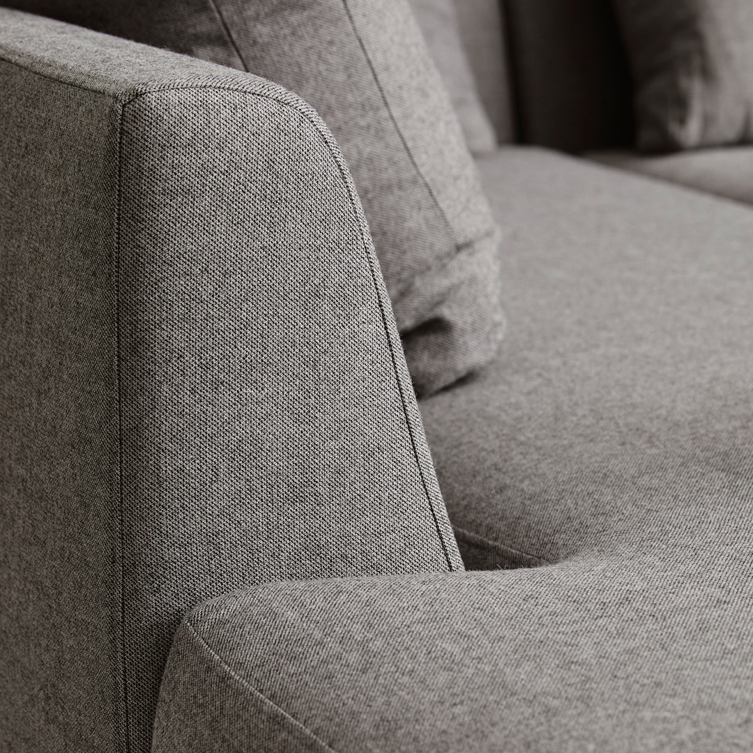 Gray textured fabric sofa with a modern design featuring clean lines and subtle stitching details.