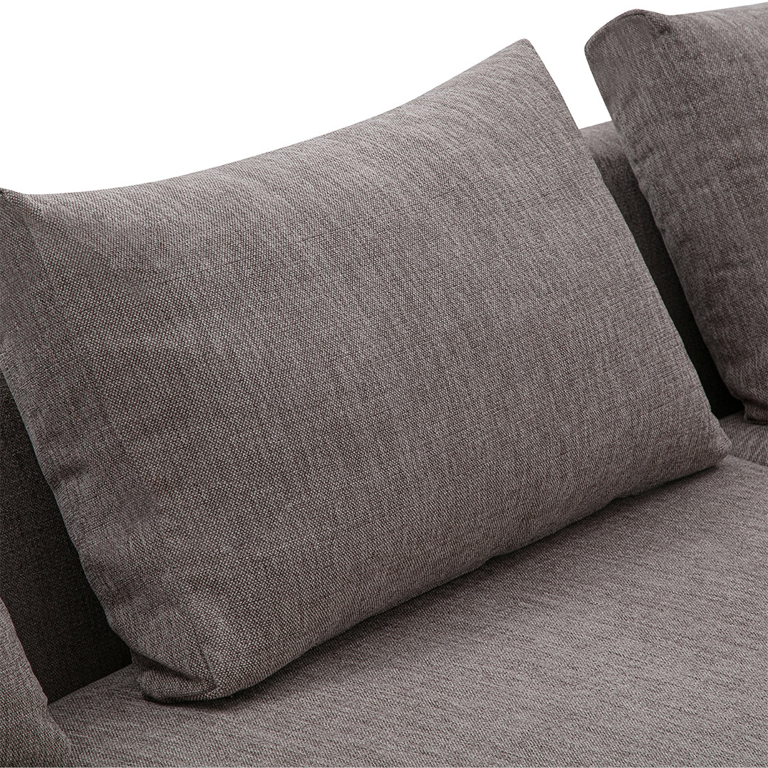 Textured gray cushion on a stylish sofa, showcasing a sleek, modern pattern for contemporary decor.