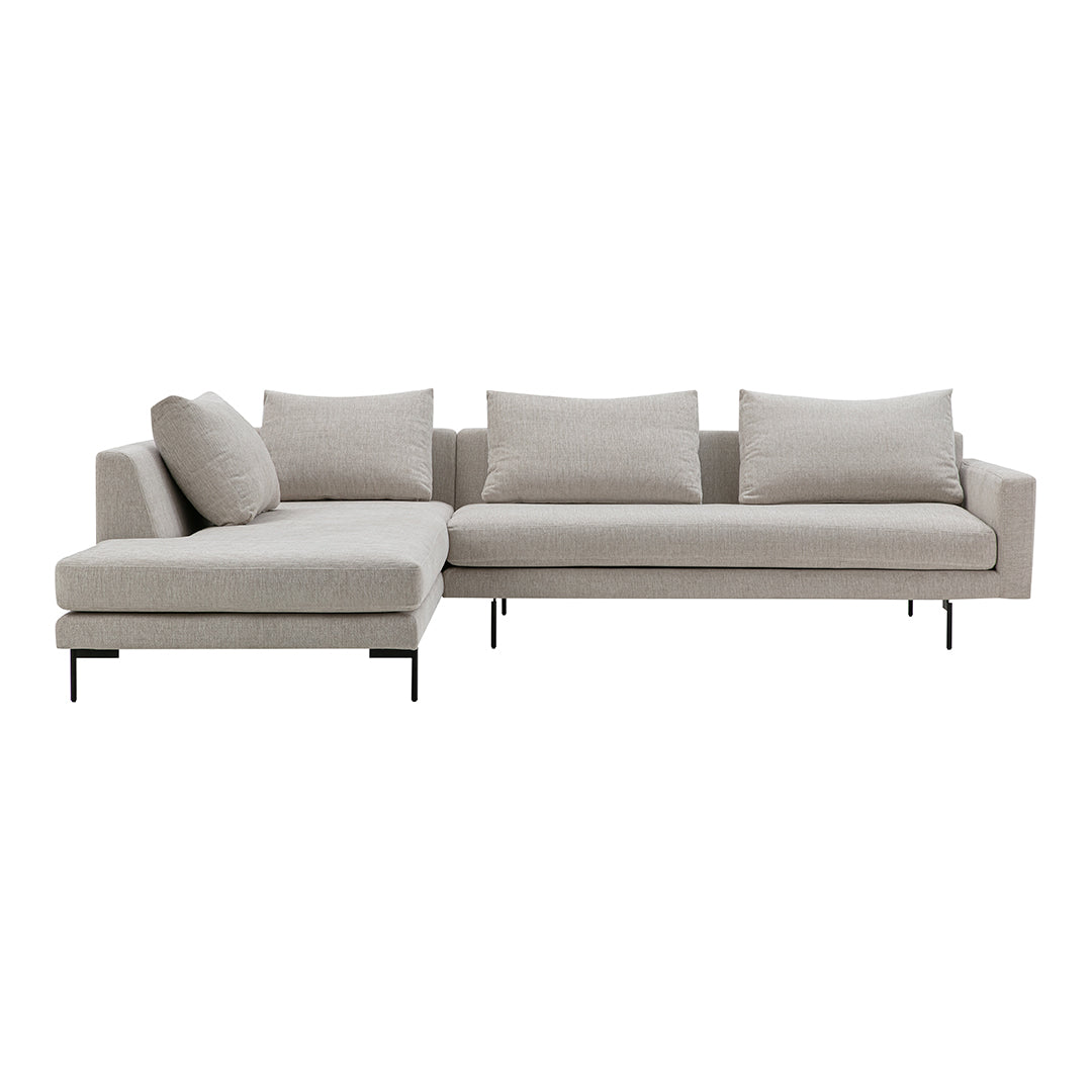Light beige sectional sofa with a simple, modern design, featuring soft, solid fabric and sleek black legs.