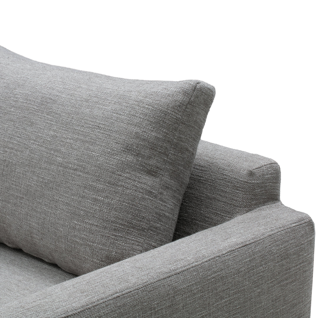 Gray textured sofa fabric with a subtle linen pattern and a supportive cushion. Perfect for modern interiors.