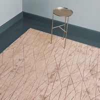 Beige area rug with geometric diamond pattern and gold accents, creating a modern and stylish interior look.