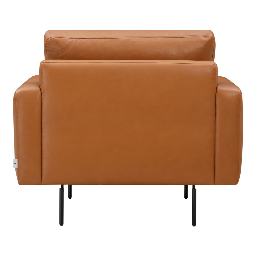 Tan leather armchair with smooth texture and minimalist black metal legs.