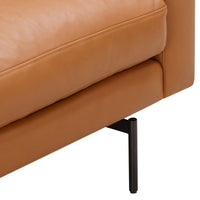 Tan leather sofa section with smooth texture and sleek black metal legs. Perfect blend of modern and classic design.