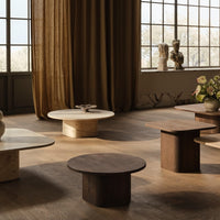 Set of minimalist coffee tables in light beige, cream, and rich brown tones with smooth, curved surfaces.