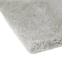 Soft gray shag rug with a plush texture, featuring subtle variations in tone and a smooth, fluffy surface.