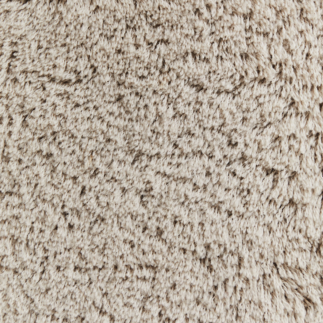 Soft beige fabric with a textured, fuzzy pattern, perfect for cozy home décor.