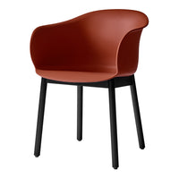 Rust-colored chair with smooth, rounded design and contrasting black legs. Ideal for modern interior decor.