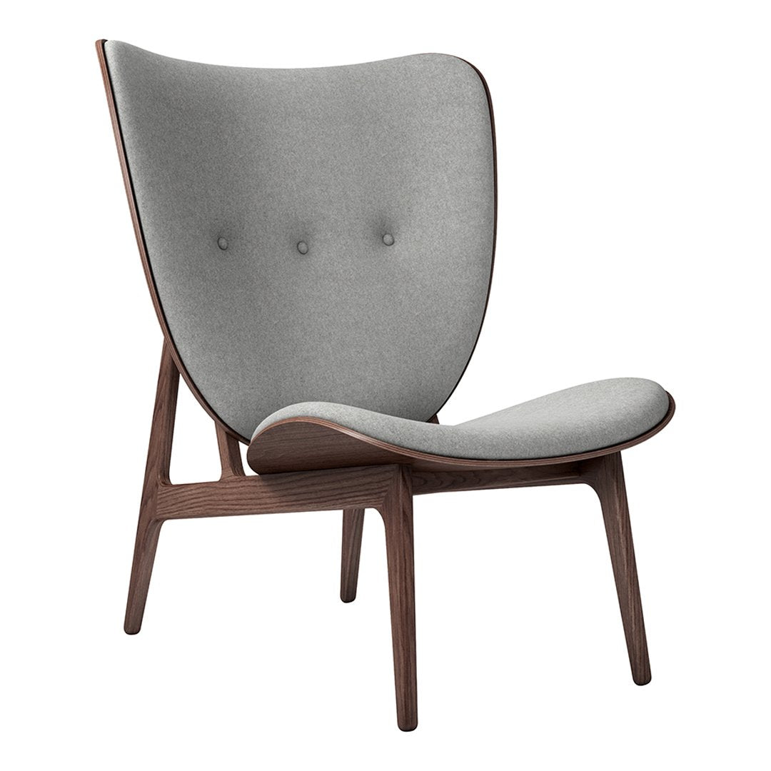 Gray upholstered chair with a smooth, rounded design and wooden legs. Features subtle tufting for added elegance.