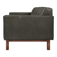 Dark green leather sofa with a matte finish and sleek wood legs, featuring subtle horizontal tufting.