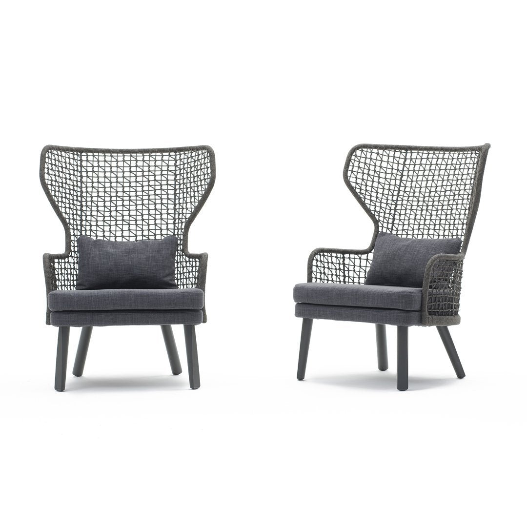 Black wicker chairs featuring geometric patterns and dark gray cushions for a modern aesthetic.