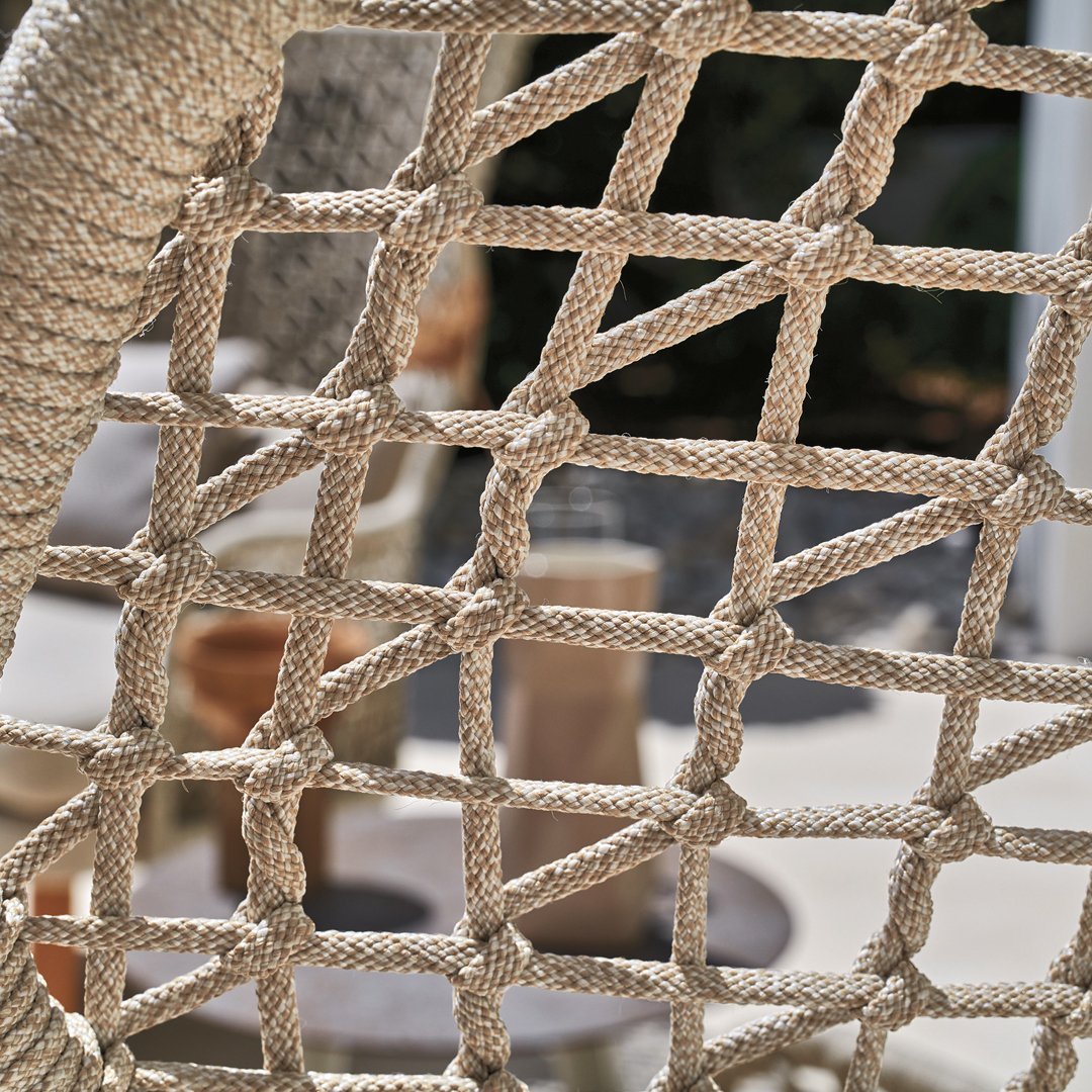 Beige rope netting with a woven pattern, providing a textured, natural look perfect for outdoor decor.