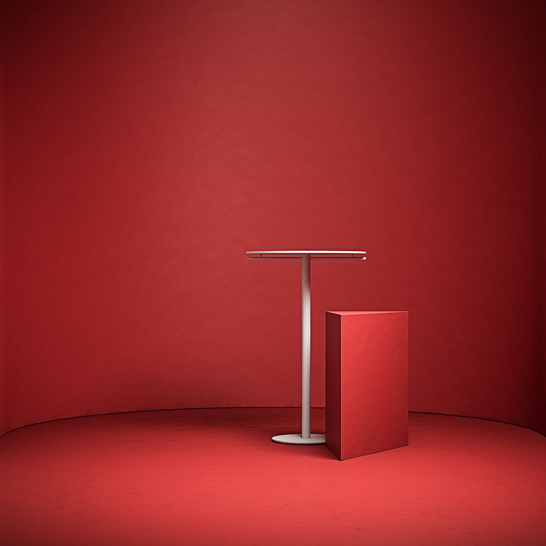 "Modern tabletop and pedestal in vibrant red against a solid red backdrop, showcasing a minimalist design."