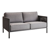 Gray upholstered two-seater sofa with black metal frame and woven side detail. Modern and stylish design.