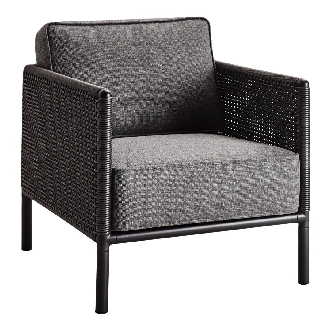 Gray upholstered chair with a woven black rattan frame, featuring sleek modern design and clean lines.
