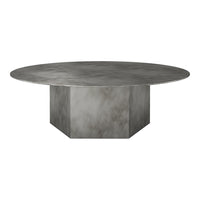 Round concrete dining table with a smooth gray finish and subtle marbled texture, featuring a geometric base.