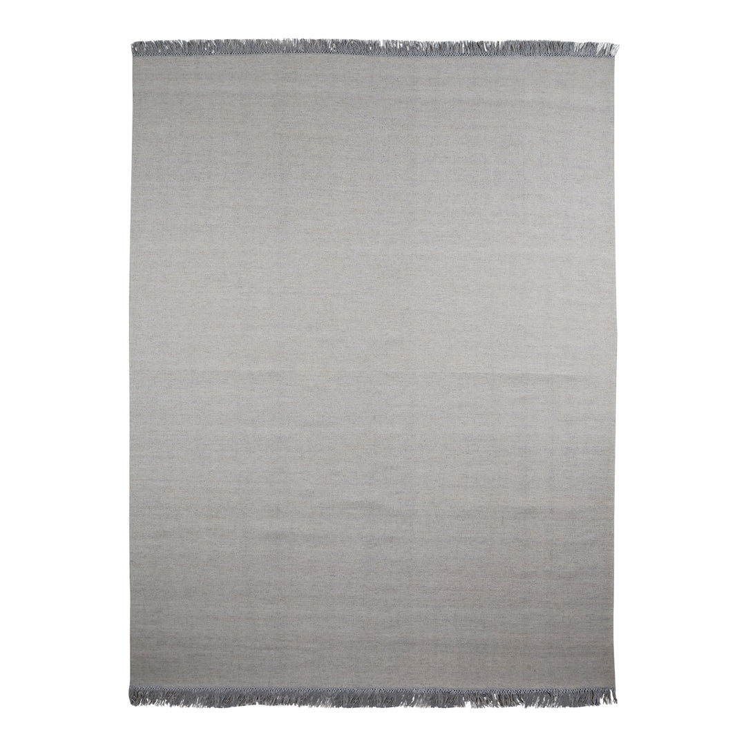 Gray woven rug with a subtle gradient pattern and fringed edges, perfect for modern decor.
