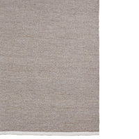 Textured beige fabric featuring subtle woven patterns. Perfect for home decor or upholstery projects.