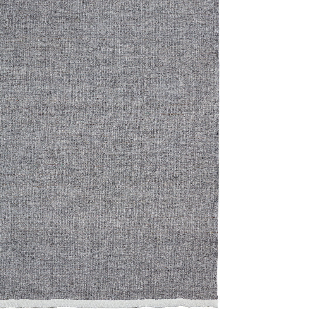 Textured gray fabric with a subtle woven pattern and a contrasting white edge. Ideal for stylish home decor.