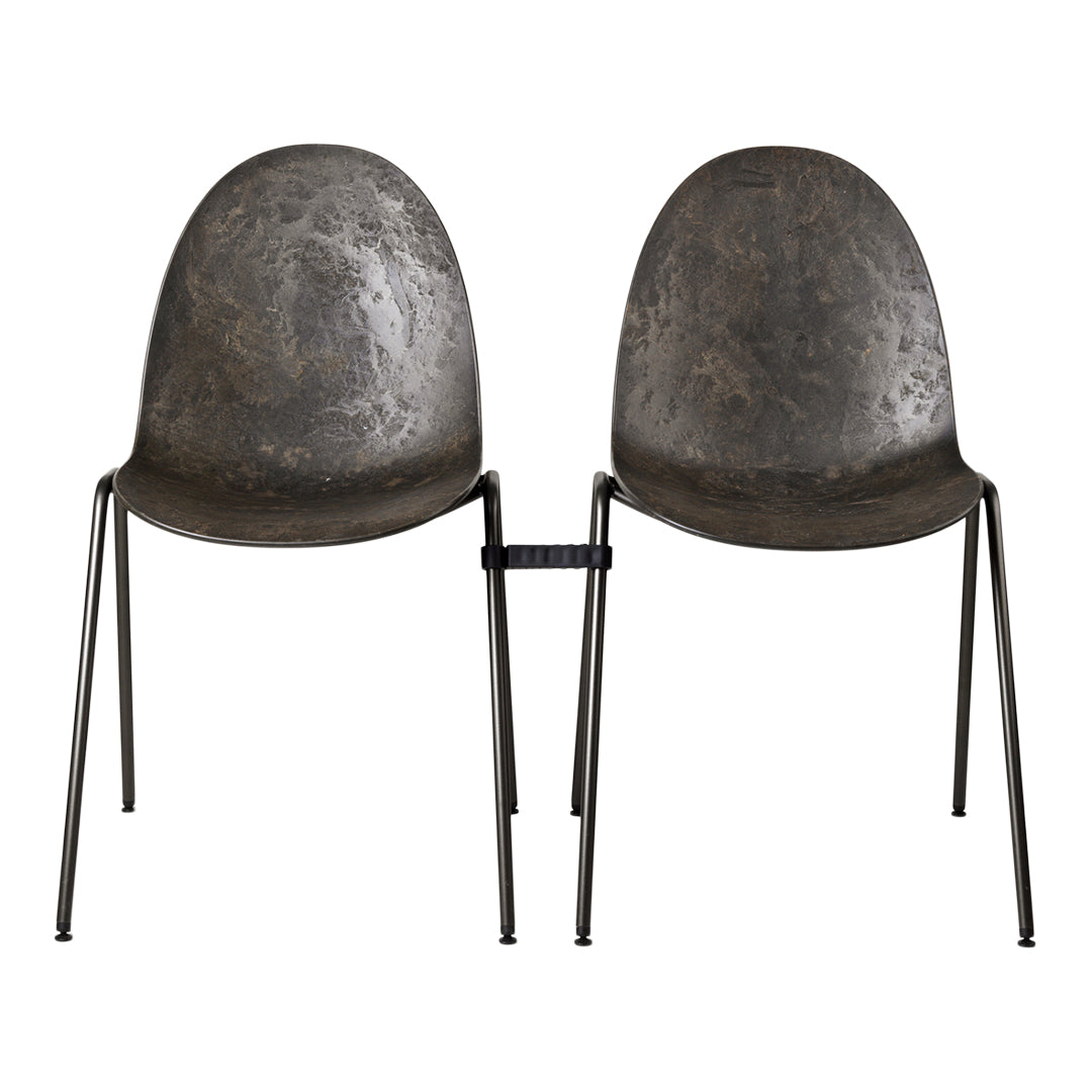 Pair of metallic gray chairs with a textured surface and black metal legs, showcasing a modern, industrial design.