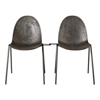 "Two modern black chairs with a textured surface and sleek metal legs, featuring a minimalistic design."