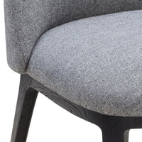 Gray fabric upholstery with a subtle texture on a modern chair, complemented by a dark wooden base.