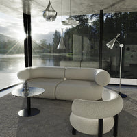 "Stylish white curved sofa with a matching armchair in a modern, minimalist setting."