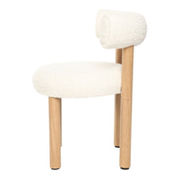 White boucle chair with natural wooden legs and a unique roll-back design. Soft, textured fabric for a cozy look.