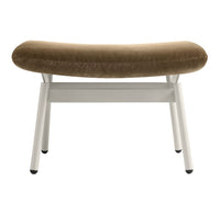 Brown velvet bench with a curved seat and white metal legs, featuring a modern minimalist design.