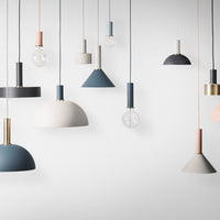 Colorful modern pendant lights in navy, blush, and gray with varied geometric shapes and metallic accents.