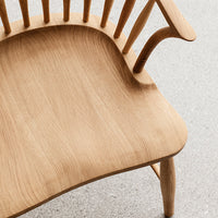 Natural oak wood with a smooth, grainy texture and light, warm tones, showcasing a minimalist design.