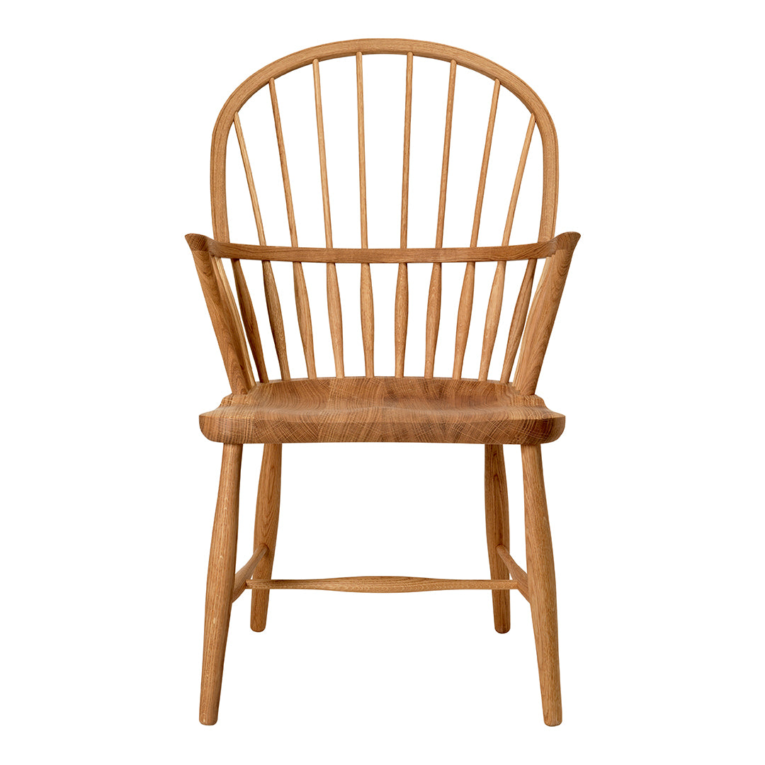 Natural wood chair with a light honey tone and classic spindled back design. Simple, elegant, and warm aesthetic.