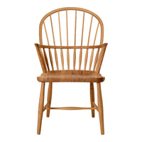 Natural wood chair with a light honey tone and classic spindled back design. Simple, elegant, and warm aesthetic.