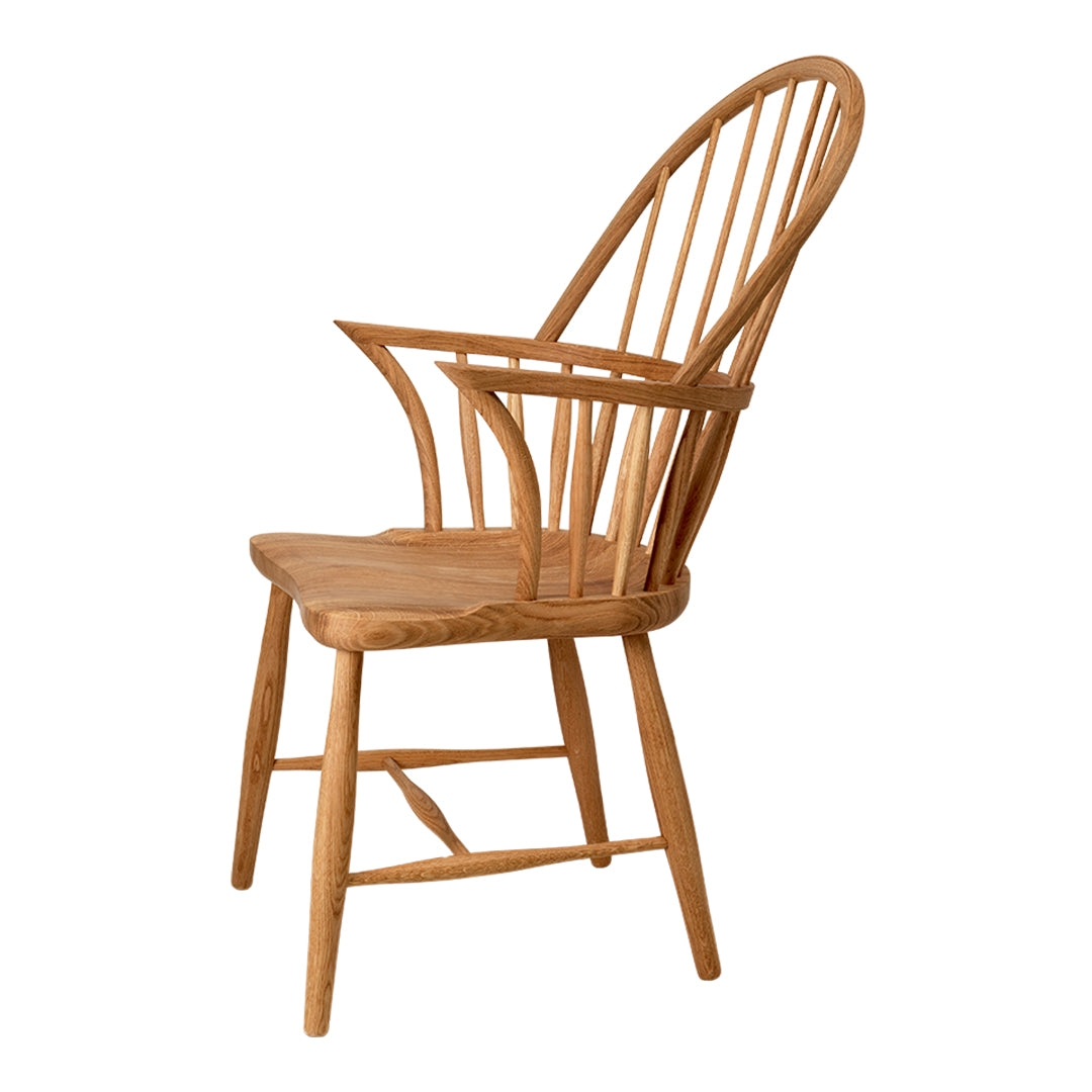 Natural wood chair with smooth, light oak finish and classic spindled back design. Perfect for any interior decor.