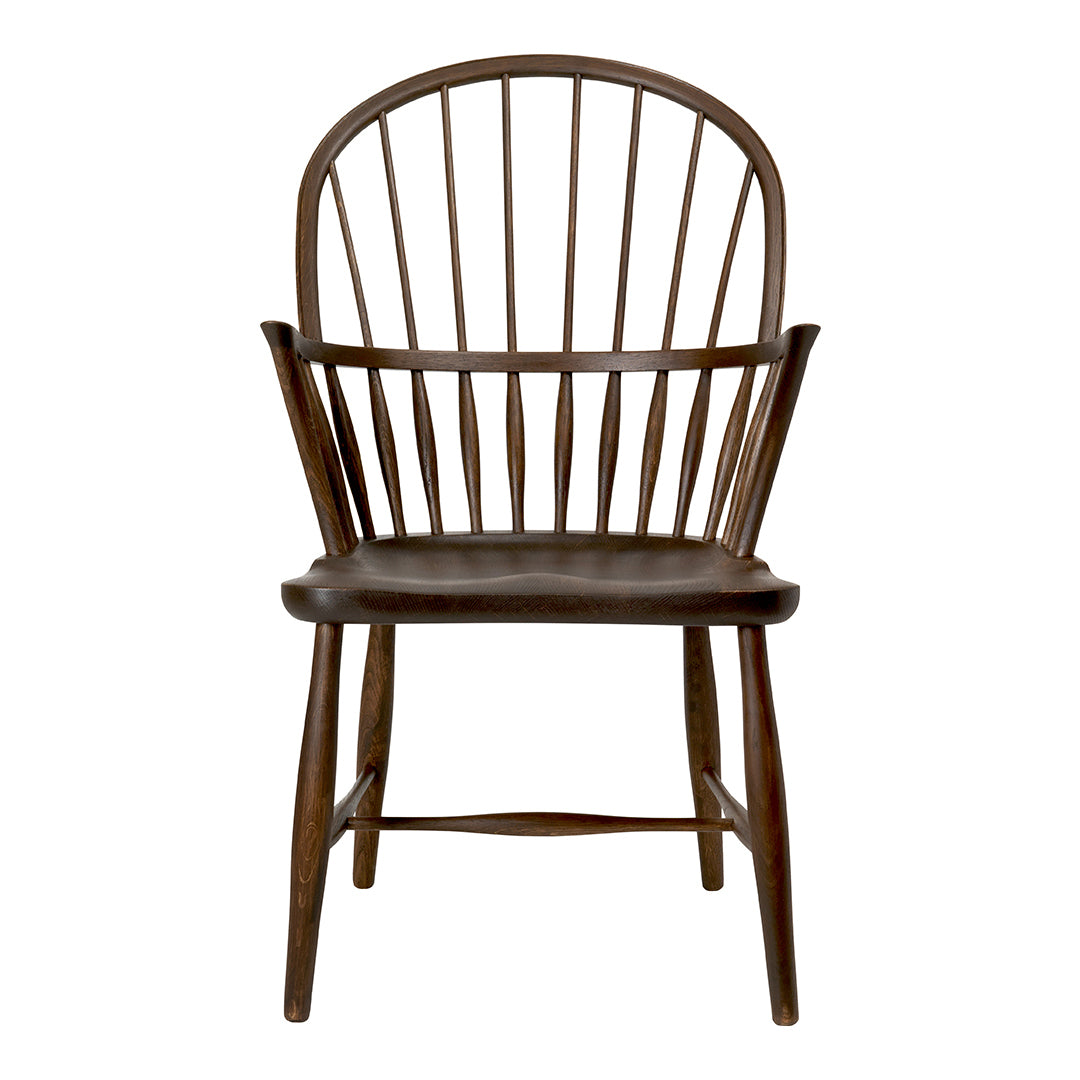 Brown wooden chair with a spindle back design and a smooth, dark seat, featuring a classic and elegant finish.