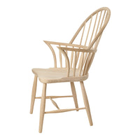 Light wood armchair with a minimalist design and slatted back, showcasing a natural finish and clean lines.