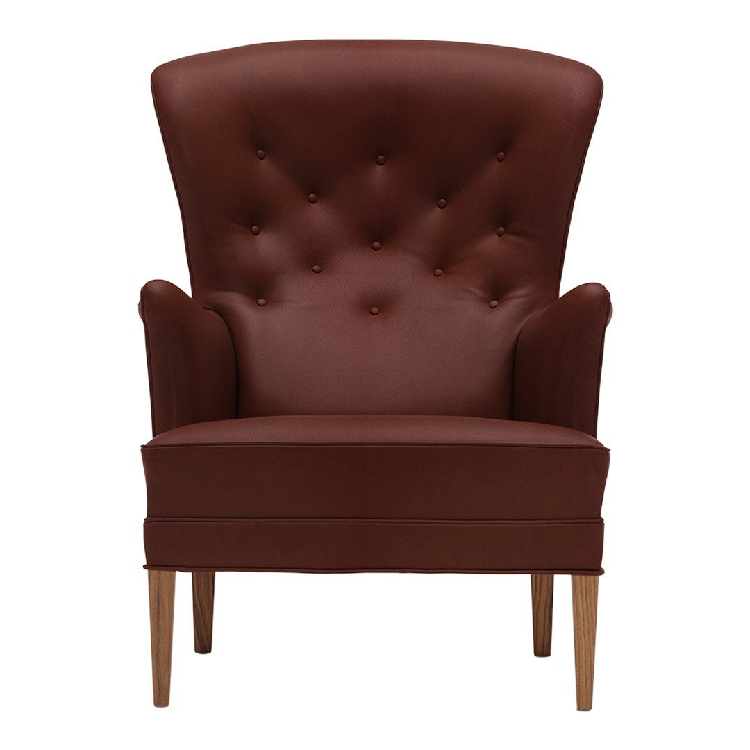 Brown upholstered armchair with a tufted back and wooden legs, featuring a classic, elegant design.
