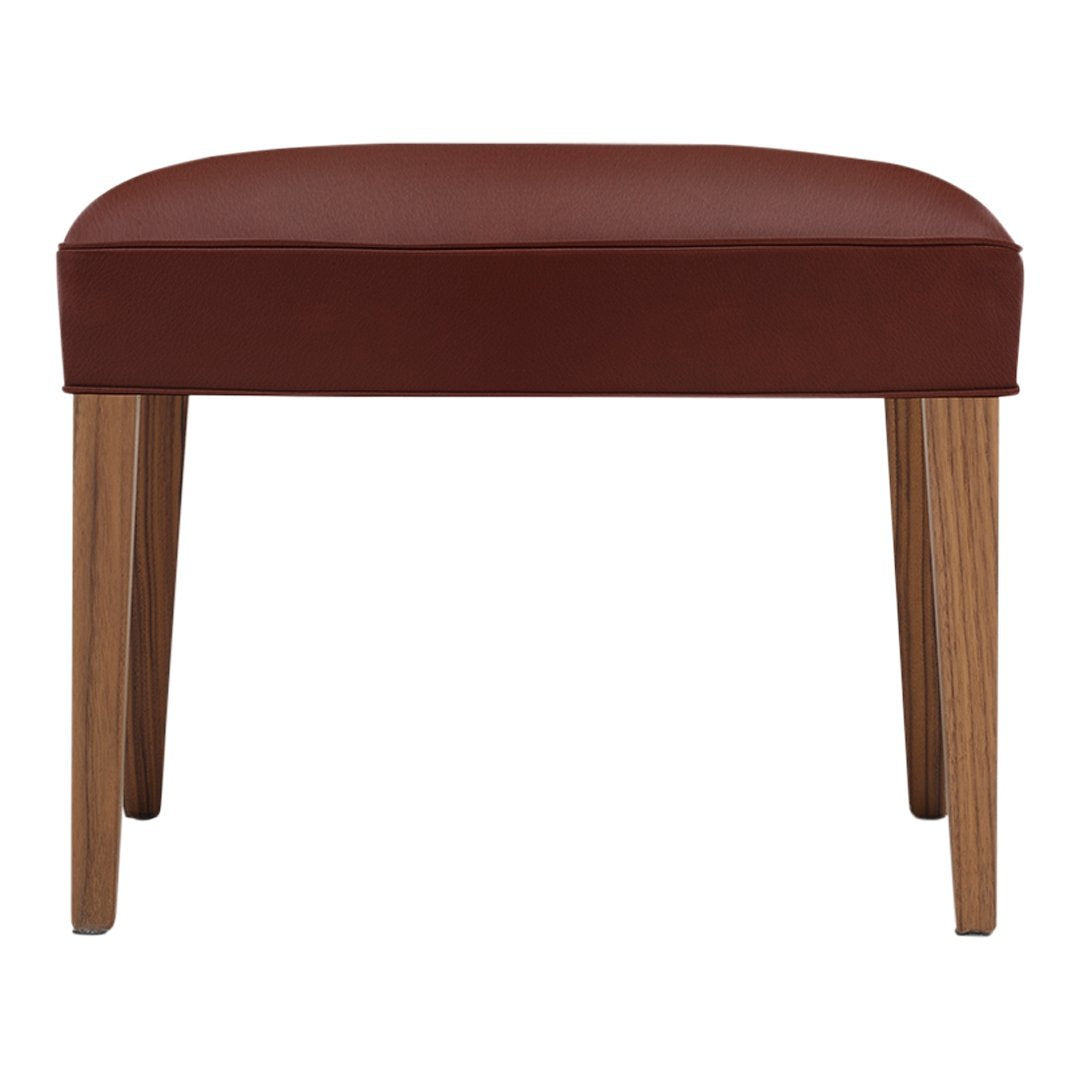 Brown upholstered stool with wooden legs, featuring a sleek, contemporary design and rich color contrast.