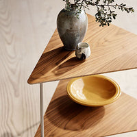 Wooden triangle tabletop with rich brown tones, textured ceramic vase in gray, and vibrant yellow bowl.